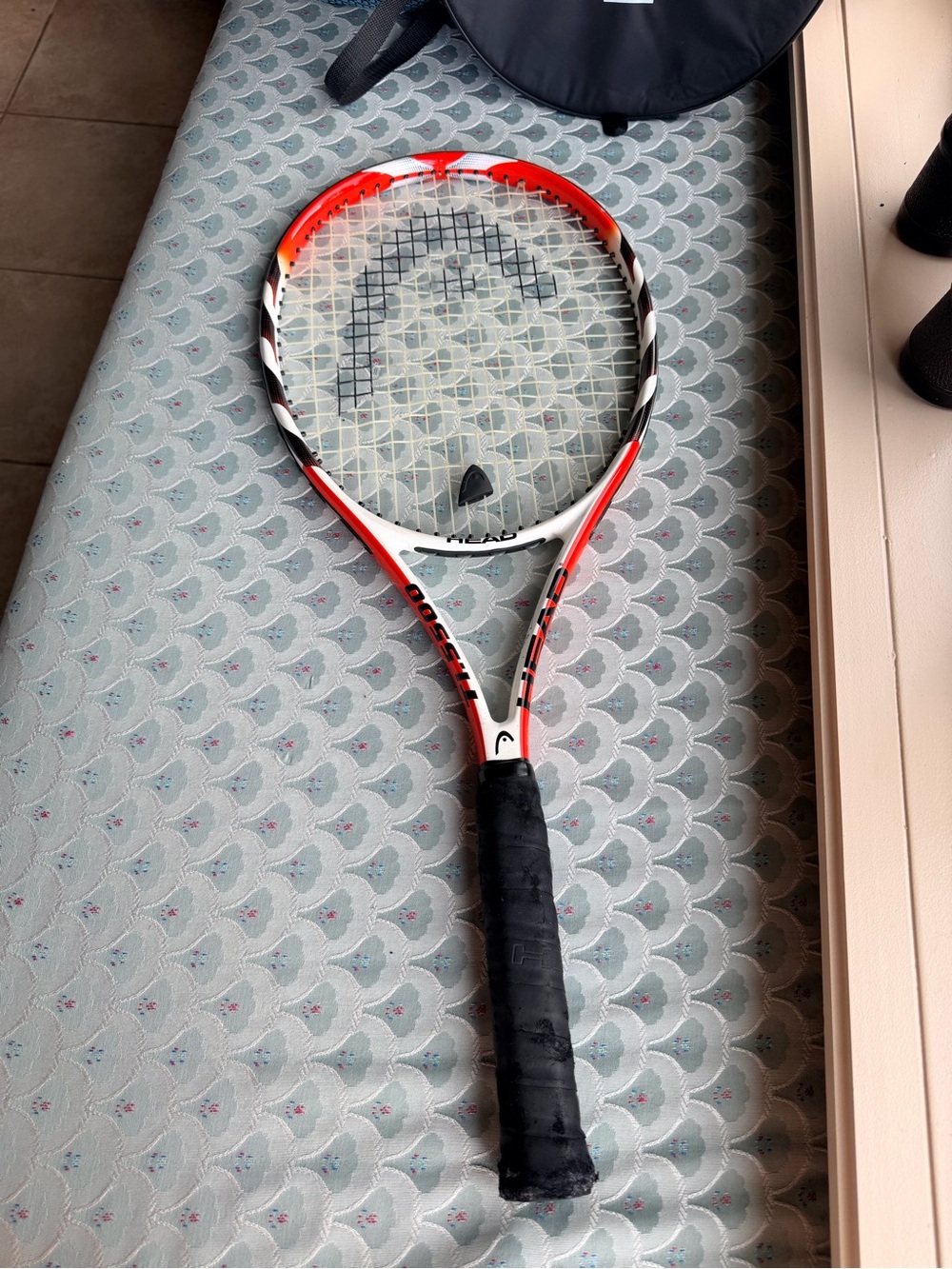 The HEAD Ti. 5500 Tennis Racket in White and Orange with Black Grip